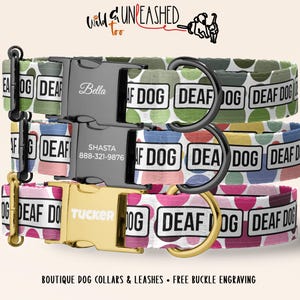 May include: Three dog collars stacked vertically, each featuring a repeating pattern of colorful polka dots and the text DEAF DOG in rectangular boxes. The collars have black or gold buckles engraved with names like Bella, Shasta, and Tucker.