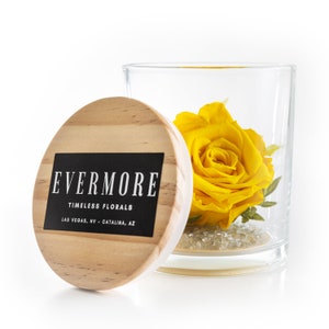 This is a beautiful preserved yellow rose in a glass jar with a wood lid. The perfect gift for someone you love.