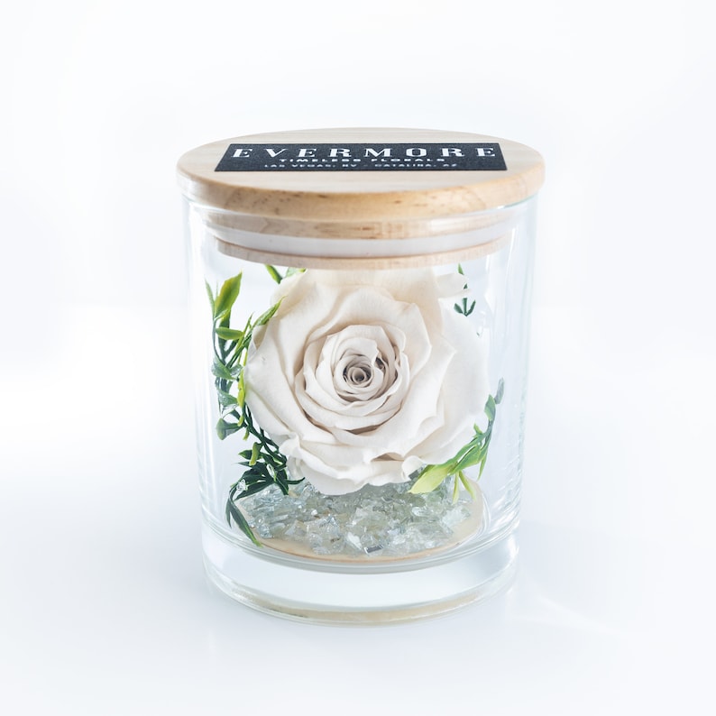 This is a beautiful preserved white rose in a glass jar with a wood lid. The perfect gift for someone you love.