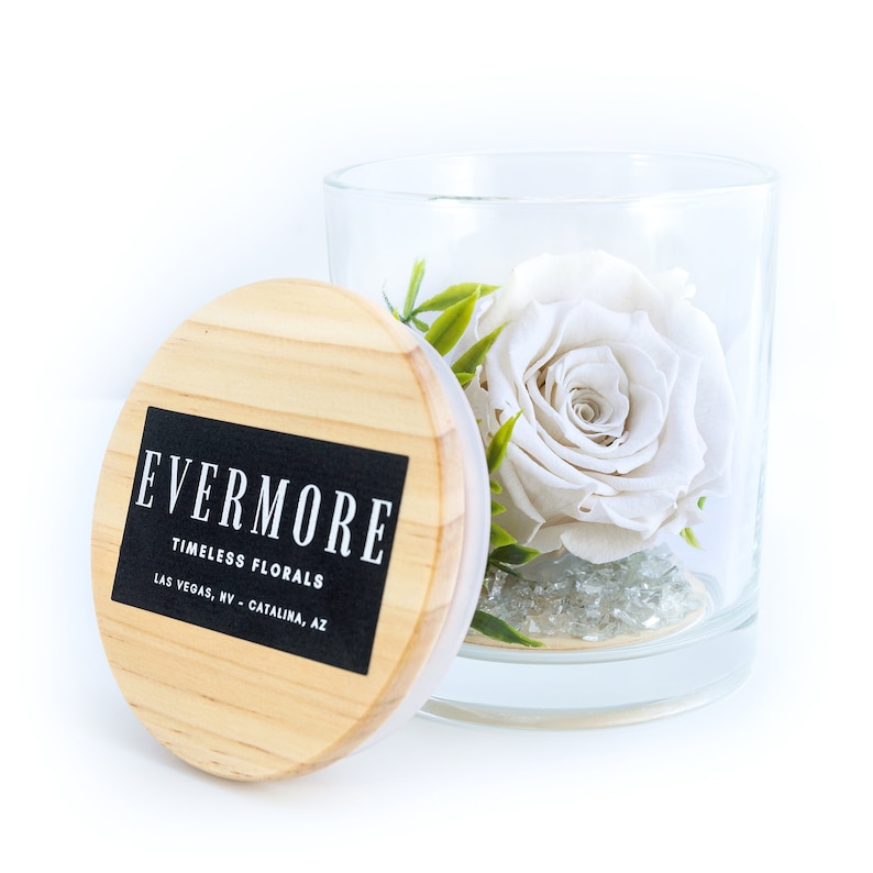 This is a beautiful preserved white rose in a glass jar with a wood lid. The perfect gift for someone you love.