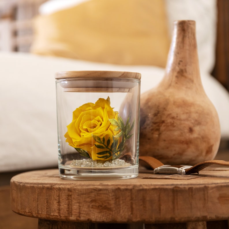 This is a beautiful preserved yellow rose in a glass jar with a wood lid. The perfect gift for someone you love.