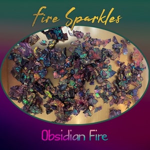 May include: Obsidian Fire Sparkles, a collection of iridescent, multi-colored, and metallic flakes. The flakes are scattered on a gold surface. The text "Fire Sparkles" is written in gold letters above the flakes, and the text "Obsidian Fire" is written in rainbow letters below the flakes.