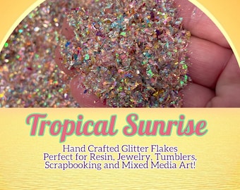 May include: A close-up of iridescent glitter flakes in a variety of colors, including pink, gold, and green. The glitter is perfect for crafting projects such as resin art, jewelry making, and scrapbooking.