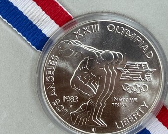 Moneda conmemorativa de los Juegos Olímpicos de Los Ángeles de 1983, dólar estadounidense de plata al 90%.