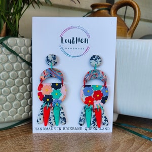 May include: A pair of colourful statement earrings with a floral design, a marbled pattern, and a turquoise and white speckled design. The earrings are handmade in Brisbane, Queensland. Lou & Hen Handmade.