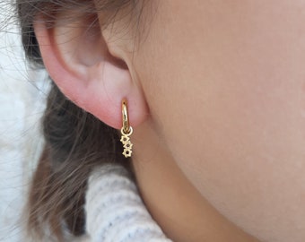 Stainless steel  Huggie hoop earrings with stars pendant.