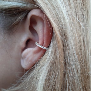 Conch ear cuff earring with zircons.