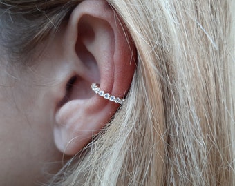 Conch ear cuff earring with zircons.