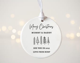 May include: White ceramic Christmas ornament with black text that reads "Merry Christmas Mummy & Daddy See You In 2025 Love From Bump" and a design of five stylized Christmas trees.
