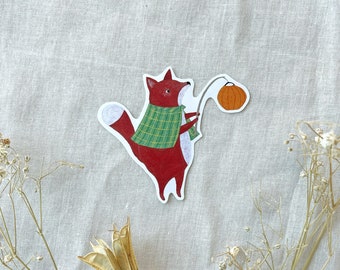 May include: A red fox wearing a green and white plaid shirt holds a small orange pumpkin on a stick. The fox is standing on a white background.