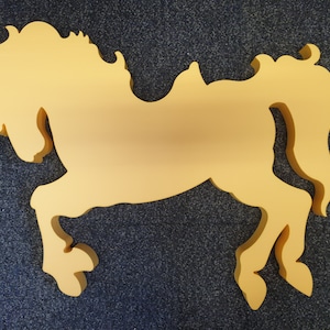 May include: A yellow silhouette of a carousel horse, with a saddle and a raised tail, against a dark grey background.