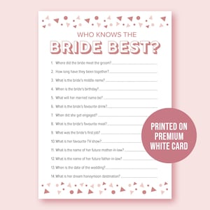 May include: A white card with the text "WHO KNOWS THE BRIDE BEST?" and questions for a bridal shower game. The card has a pink and white confetti design and a pink circle that says "PRINTED ON PREMIUM WHITE CARD."