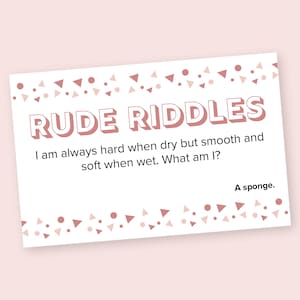 May include: A white card with pink and white confetti border. The card has the text "RUDE RIDDLES" in bold, pink letters. The riddle is "I am always hard when dry but smooth and soft when wet. What am I?" The answer is "A sponge."