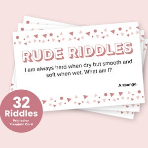 May include: A stack of white cards with pink and white confetti designs. The cards feature rude riddles with the text "RUDE RIDDLES" in pink. One card reads "I am always hard when dry but smooth and soft when wet. What am I? A sponge."