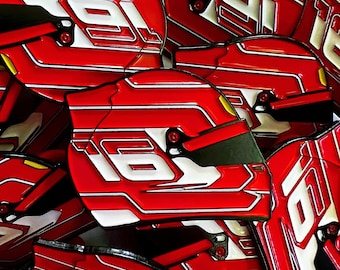 May include: A collection of red racing helmets with white and yellow accents. Each helmet features the number "16" or "91" in white. The helmets have a glossy finish and a visor.