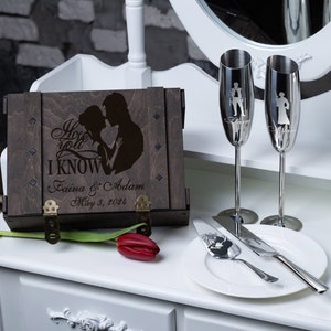 May include: A wooden box with a hinged lid, engraved with a couple's silhouette and the text "I hope you I KNOW", "Faina & Adam", and "May 3, 2024". Two champagne flutes and a cake knife are also engraved with a couple's silhouette.