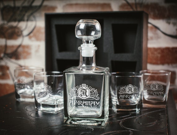 Engraved whiskey decanter paired with glasses in a handsome oak wood presentation box — a complete gifting moment, not just a single item.
