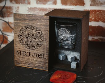 May include: A wooden box with a glass tumbler and whiskey stones. The box is engraved with a circle of symbols and the name "MICHAEL".