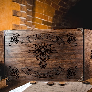 May include: A wooden Dungeon Master screen with intricate dragon and scroll designs. The screen is made of dark brown wood and features the words "DUNGEON MASTER" in a banner. Decorative metal corner pieces and accents are visible.