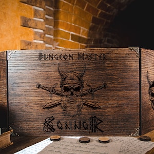 May include: A wooden Dungeon Master screen with the text "DUNGEON MASTER" and "BONNOR" engraved on the front. The screen features a skull with crossed swords and horned helmets. The wood has a dark brown finish.