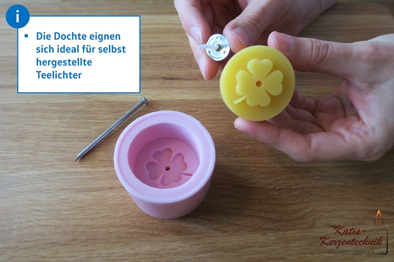 May include: A pink silicone mold with a four-leaf clover design. A yellow candle with a four-leaf clover design is being removed from the mold. The candle has a metal wick attached to the top.