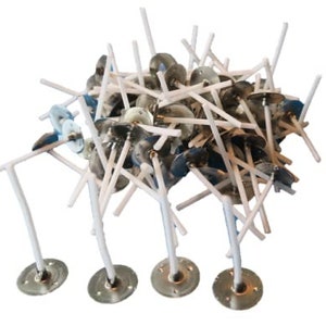May include: A pile of white candle wicks with metal bases. The wicks are arranged in a random pattern and are all the same size. The bases are silver and have a small hole in the center.