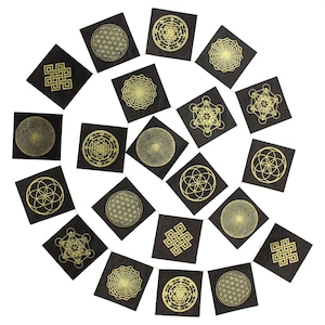 May include: A garland of black fabric flags with gold geometric designs, including the Flower of Life, the Seed of Life, and the Merkaba. The flags are strung together with a white cord.