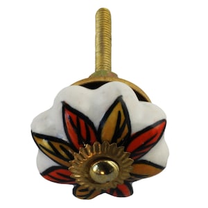 May include: White ceramic cabinet knob with a red, orange, and yellow flower design. The knob has a gold-colored screw and a gold-colored base.