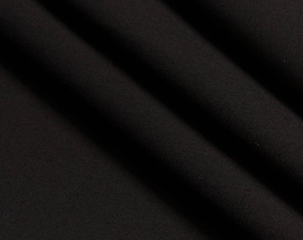 May include: Black fabric with a smooth, even texture. The fabric is folded and draped, creating soft folds and curves.