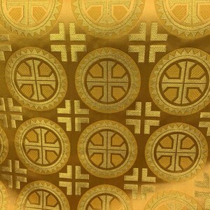 May include: Gold fabric featuring a repeating pattern of circular designs and crosses. The circles contain a cross at the centre and are framed by a decorative border. The crosses are evenly spaced across the fabric.