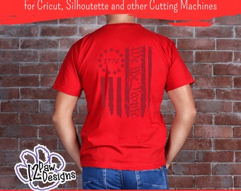 May include: Red t-shirt with a distressed American flag design featuring the text "We the People" and "1776".