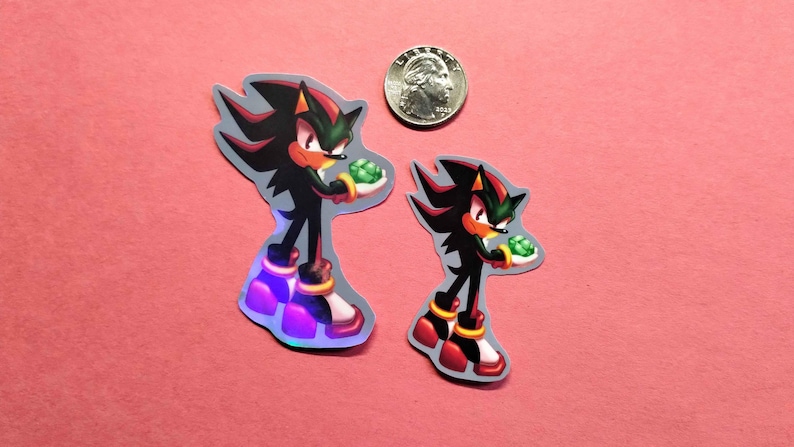 Holographic and glossy shadow the hedgehog with emerald stickers next to quarter for measure