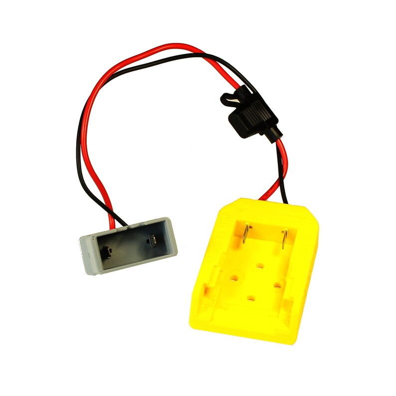 May include: A yellow battery charger with a black connector and red and black wires. The charger has two slots for batteries.