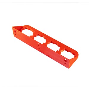 May include: A red plastic wall mount with four slots for holding screws. The mount has the text "#8 screws PLA A14" printed on it.