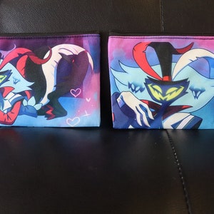 May include: Two zippered pouches with a colorful design featuring a cartoon character with a black mask, red horns, and a white and blue costume. The character is set against a blue and purple background with white hearts.