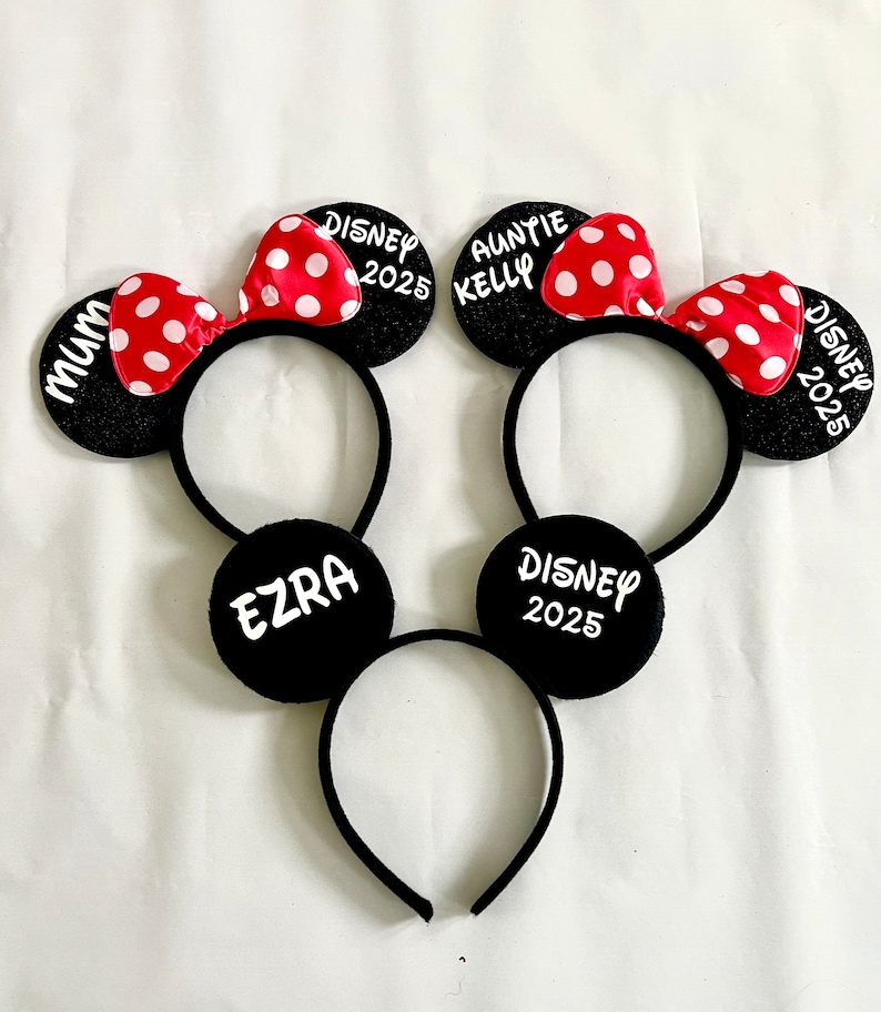 black mouse ears headbands with red and white polka dot bows or no biws. The headband on the left has any name you like and the other has 'Disney 2025' on the ear. can be customised to say anything you like.