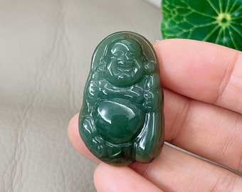 May include: A green jade pendant carved in the shape of a smiling Buddha. The pendant is smooth and polished, with a glossy finish.