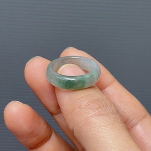 May include: A light green jade ring with a smooth, polished finish.