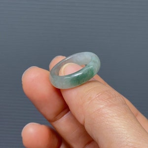 May include: A light green jade ring with a smooth, polished finish.