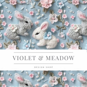 May include: Embroidered design featuring two white and grey bunnies with pink ears and blue accents, surrounded by delicate floral embroidery in shades of pink, blue, and green on a light blue background. The text "VIOLET & MEADOW DESIGN SHOP" is displayed below the bunnies.
