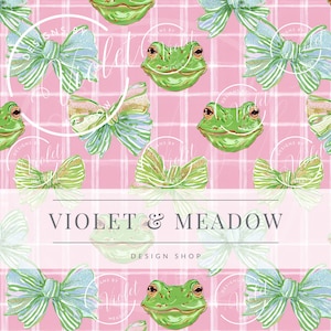 May include: A repeating pattern featuring green frog faces and bows in shades of green, blue, and gold, set against a pink plaid background. The text "VIOLET & MEADOW DESIGN SHOP" is displayed at the bottom.