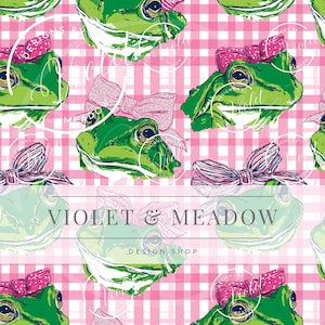 May include: A repeating pattern featuring green frog illustrations with pink bows on a pink and white gingham background. The text "VIOLET & MEADOW DESIGN SHOP" is displayed across the center of the image.