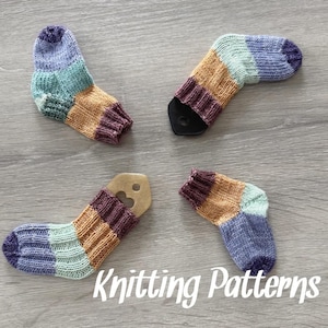 May include: Four pairs of knitted socks in a variety of colors, including purple, teal, and orange. The socks are arranged in a cross pattern on a wooden surface. Knitting Patterns.