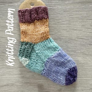May include: A colorful striped knitted sock with a purple, orange, teal, and blue color scheme. The sock is made with a fine yarn and has a ribbed texture.