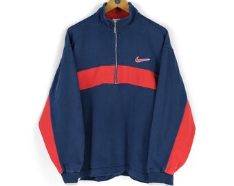 Vintage Nike half-zip sweatshirt in blauw en rood, vervaagd, maat M/L, jaren 90 sportkleding.