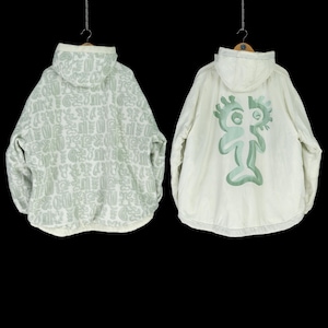 May include: Two white hooded jackets. One jacket has a green abstract pattern all over. The other jacket has a green cartoon figure on the back.
