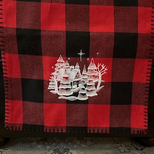 Embroidered Buffalo plaid table runner with white Christmas scene