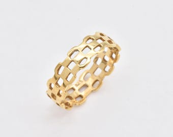 May include: A gold ring with a geometric design. The ring is made of a series of interlocking squares.