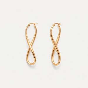 May include: A pair of gold hoop earrings featuring a twisted infinity loop design. Each earring is constructed from a continuous polished gold wire that crosses over itself to form a vertical figure-eight shape with a secure post closure.