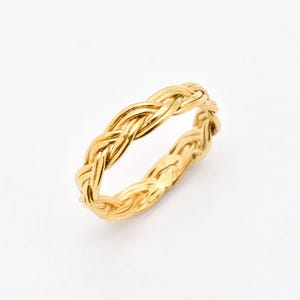 May include: A gold braided ring with a simple design.
